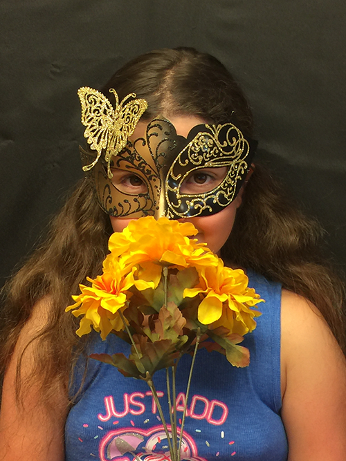 Girl wearing the Mariposa butterfly dancer mask.